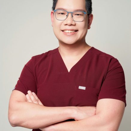 Zhengjie Lim in a burgundy shirt and glasses against a grey studio background